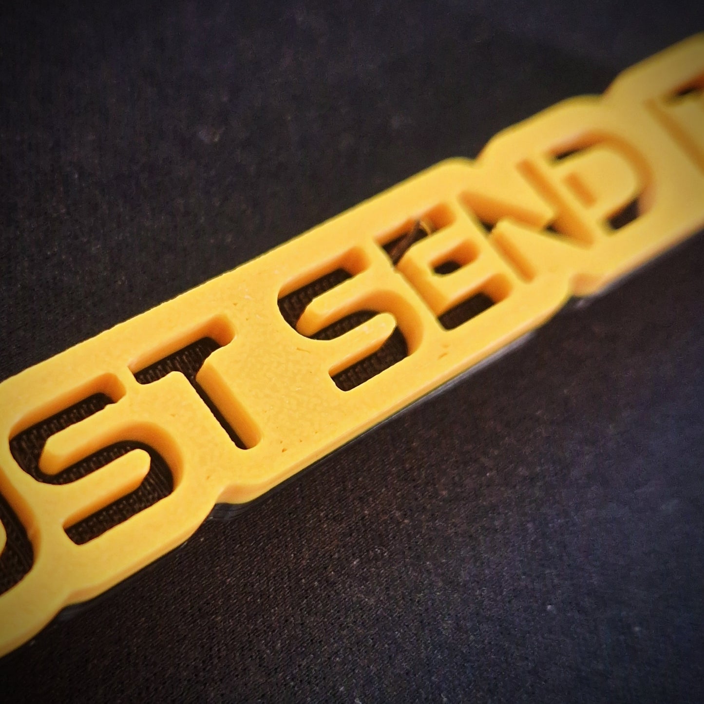 close up, 3d printed yellow just send it car keyring